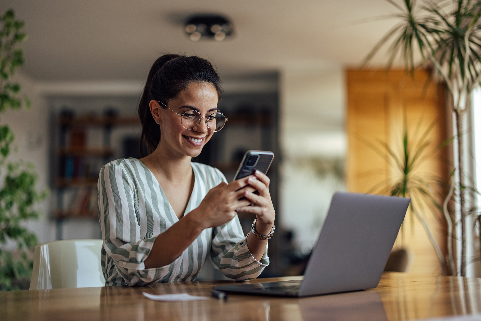 photo of a woman looking at her hand-held smart phone.