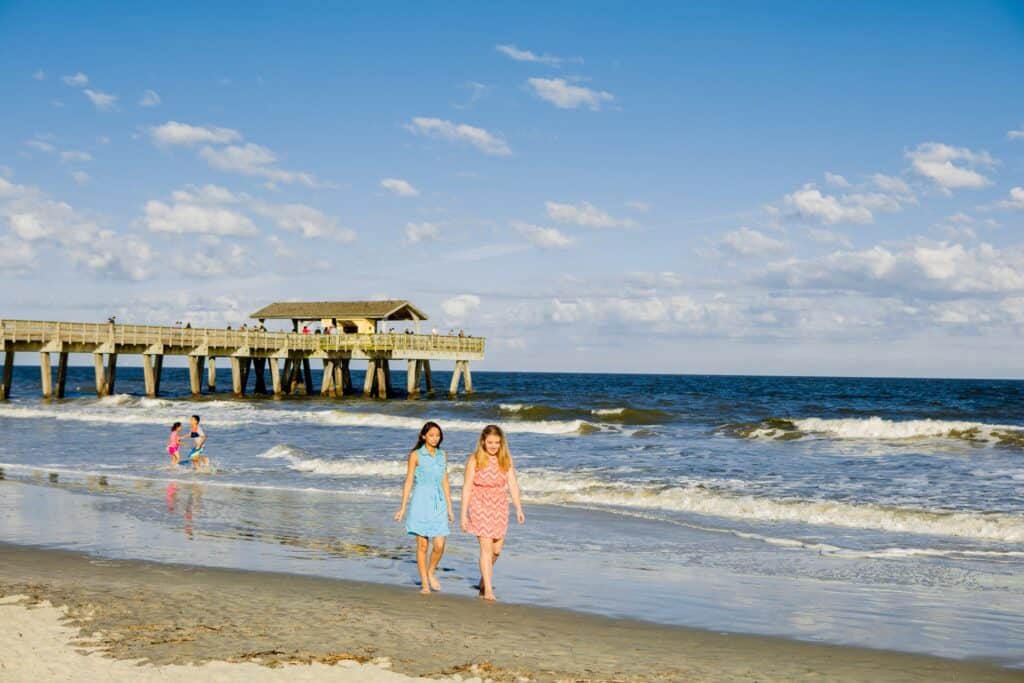 Tybee coast with women and family walking along shore